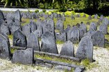 In the Maldives, being a Muslim country, people are buried. Tombstones with a single point on the top are those of men, while those  with a rounded top are those of women.<br/><br/>

Asia's smallest and least-known nation, the Republic of Maldives, lies scattered from north to south across a 750-kilometre sweep of the Indian Ocean 500 kilometres south-west of Sri Lanka. More than 1000 islands, together with innumerable banks and reefs, are grouped in a chain of nineteen atolls which extends from a point due west of Colombo to just south of the equator.<br/><br/>

The atolls, formed of great rings of coral based on the submarine Laccadive-Chagos ridge, vary greatly in size. Some are only a few kilometres square, but in the far south the great atoll of Suvadiva is sixty-five kilometres across, and has a central lagoon of more than 2000 square kilometres. The northern and central atolls are separated from each other by comparatively narrow channels of deep water, but in the south Suvadiva is cut off by the eighty-kilometre-wide One-and-a-half-Degree Channel. Addu Atoll is still more isolated, being separated from the atoll of Suvadiva by the seventy-kilometre-wide Equatorial Channel.