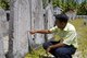 Maldives: Hassan Shahid, Island Chief Councilor, pointing out the ancient Dhivehi (Divehi) script at the oldest cemetery in the country, Hulhumeedhoo Island, Addu Atoll (Seenu Atoll)